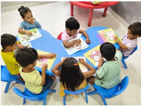 Children colouring around the activity table